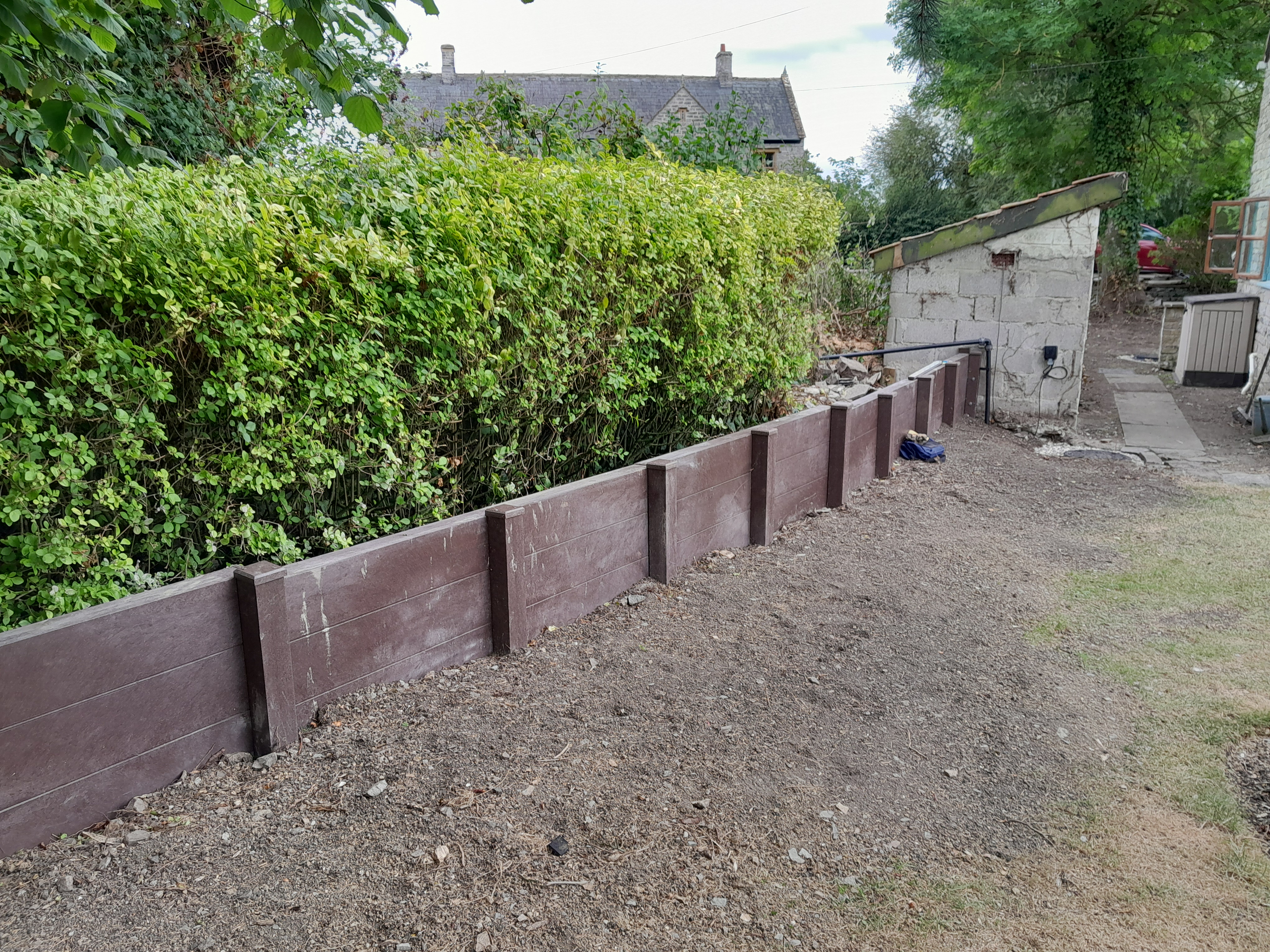 Section of flood barrier with sump pump chamber